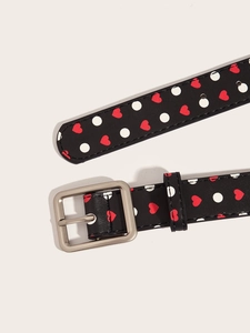 Detail view of Y2K vintage belt with red hearts and white polka dots on black leather