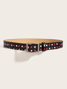Detail of Y2K vintage belt with red hearts, white dots, and silver buckle on black leather