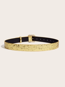 Detail of glittery gold women's belt featuring shimmering texture and a square metal buckle