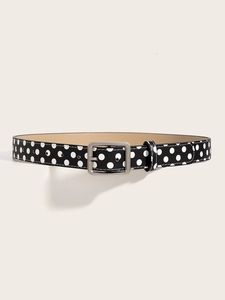 Detail of a vintage Y2K black belt with white polka dots and silver metal buckle