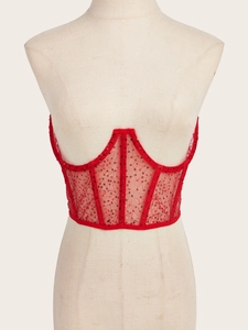 Detailed close-up of red sequined mesh corset top with supportive fishbone structure