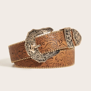 Close-up of retro western belt showing embossed floral leather and carved gold metal hardware