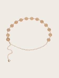 Detail of vintage golden chain belt featuring hollow-out floral patterns and metal texture