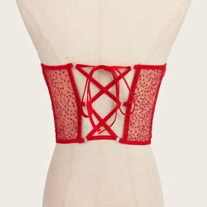 Red sequin lace-up corset belt with criss-cross ribbon ties on a professional mannequin