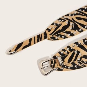 Punk style zebra print waist belt with silver studs and western buckle on white background