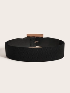 Detail of black elastic wide waist belt with rose gold rectangular metal buckle