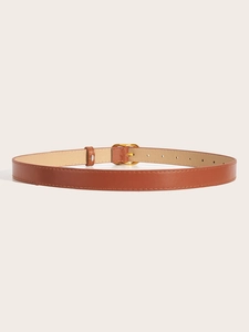 Detail view of a slim brown leather belt with gold square buckle and reinforced stitching