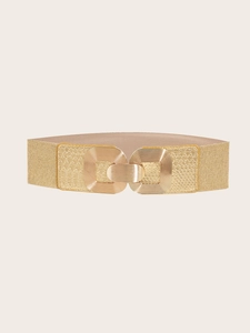 Detailed close-up of golden elastic corset belt buckle with textured snakeskin finish