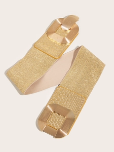 Detailed macro view of the gold elastic waist belt with vintage textured buckle