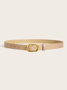 Close-up of beige thin belt with oval gold buckle against a minimal neutral background