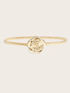 Detailed close-up of a golden spring waist belt with an elegant rose buckle design