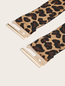 Detail of leopard print elastic waist belt featuring a polished gold metal buckle
