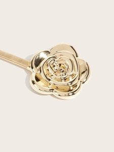 Close-up of golden rose buckle with elastic metal spring belt for women dresses