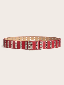 Close-up of a red punk leather belt with triple rows of silver metal eyelets and buckle
