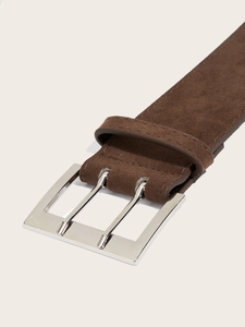 Detailed close-up of brown suede belt with silver double-pin metal buckle and stitching