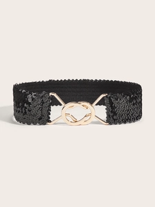 Detailed macro view of black sequin elastic waist belt with interlocking gold buckle