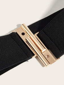 Detailed macro view of the gold alloy clasp and black elastic woven waist belt
