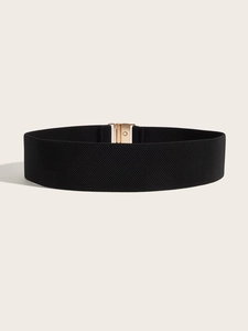 Detailed view of wide black elastic corset belt with a polished gold rectangular buckle