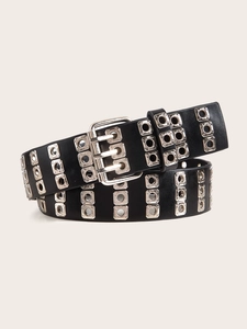 Detail of punk style black leather belt with silver double prong buckle and metal eyelets