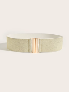 Detail of champagne gold wide elastic belt with polished metallic buckle closure