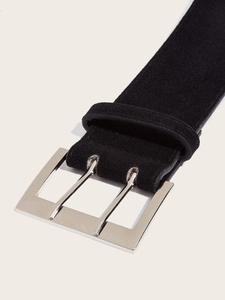 Close-up of black suede belt with a polished silver double-prong rectangular buckle