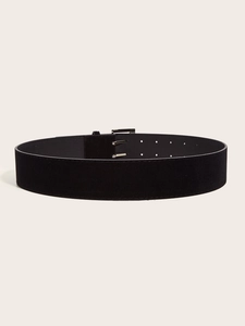 Detail view of black suede wide belt featuring a retro silver double prong metal buckle