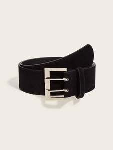Detail of black suede waist belt featuring a polished silver double-prong metal buckle