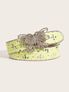 Détail de la ceinture Y2K vert fluo avec paillettes et boucle papillon argentée rétro
