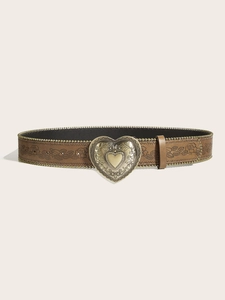 Detail of vintage heart-shaped bronze buckle and rose embossed brown leather belt