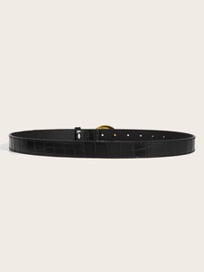 Detail of black crocodile embossed leather belt featuring a vintage gold metal buckle