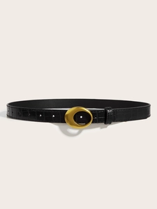 Detail view of black crocodile pattern leather belt with a matte gold crescent buckle