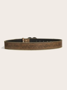 Close-up of brown leather belt with floral embossing and gold stud detailing