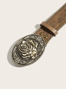 Macro shot of vintage leather belt with floral embossing and bronze rose relief buckle