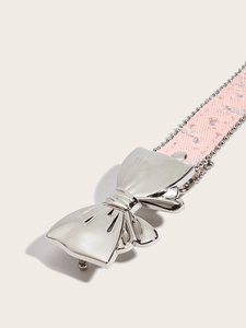 Detail of pink canvas belt with silver butterfly buckle and metallic star studs