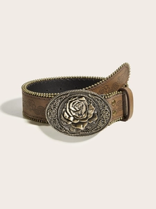 Close-up of vintage brown leather belt with embossed floral buckle and leaf pattern
