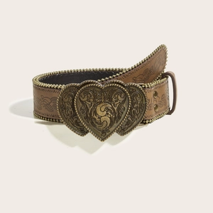 Detail of bohemian belt with floral embossing and bronze heart buckle