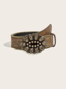 Detail of vintage brown leather belt with embossed floral patterns and studded bead edges