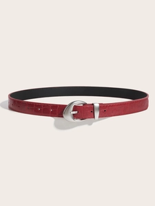 Detail shot of a burgundy women's belt featuring crocodile texture and a silver moon buckle