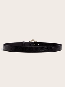 Detail of black faux leather belt with crocodile texture and gold flower petal buckle