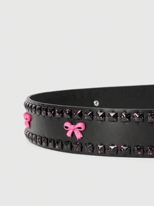 Detail of punk black belt with pink splatter rivets and a 3D bow decoration