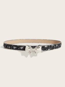 Detail of black canvas belt featuring a silver butterfly buckle and sparkling sequin accents