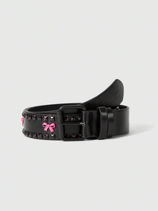 Detail of black leather punk belt with double square studs and pink bow decoration