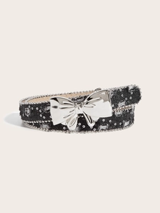 Detail of canvas belt with silver sequin dots and large metallic butterfly buckle