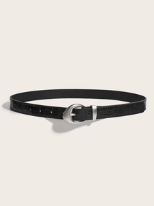 Detailed close-up of a black faux crocodile leather belt with a silver oval metal buckle