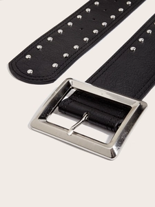 Close-up of black leather punk belt with silver rivets and large square metal buckle