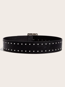 Detail of a wide punk black leather belt with double rows of silver metal rivets