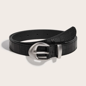 Women's black crocodile embossed leather belt with matte silver buckle on beige background
