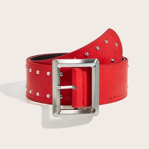 Close-up of a wide red leather belt featuring double rows of round silver stud rivets