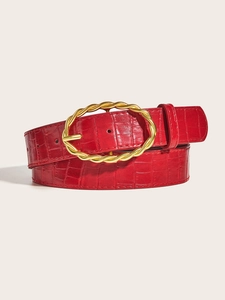 Detailed macro of burgundy belt with crocodile texture and golden braided oval buckle