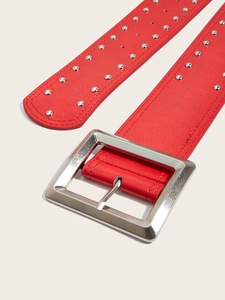 Close-up of red leather punk belt featuring double-row silver metal studs and buckle